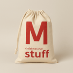Natural drawstring bag with red text 'M christmas eve stuff' on a beige background