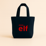 Navy tote bag with 'mini elf' text in red on a beige background