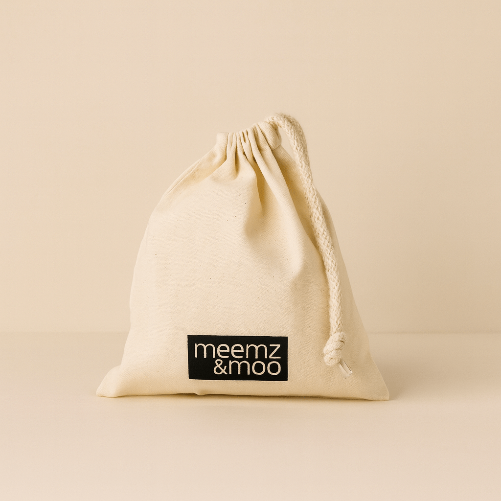 Natural drawstring bag with 'meemz & moo' label on a beige background