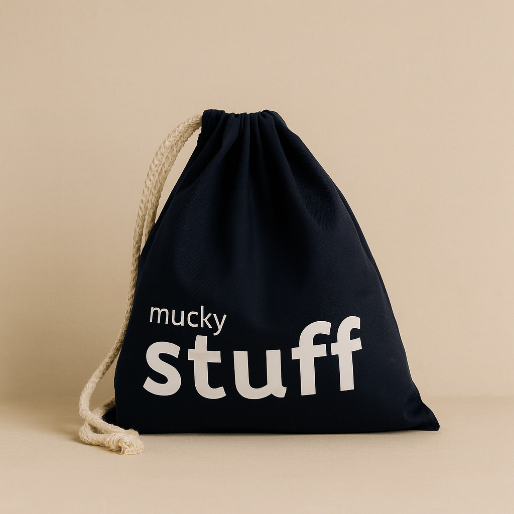 Navydrawstring bag with 'mucky stuff' text on a beige background