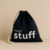 Navydrawstring bag with 'mucky stuff' text on a beige background