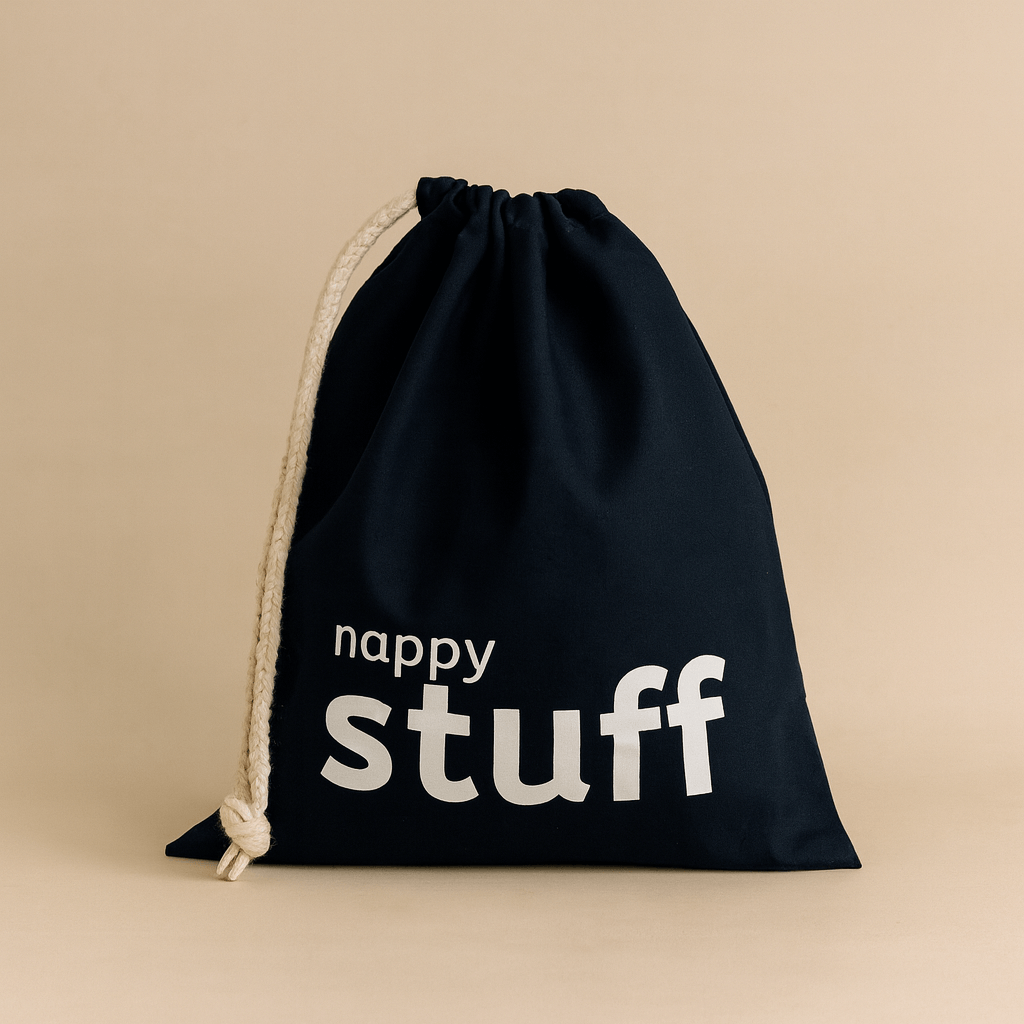 Navy drawstring bag with 'nappy stuff' text on a beige background