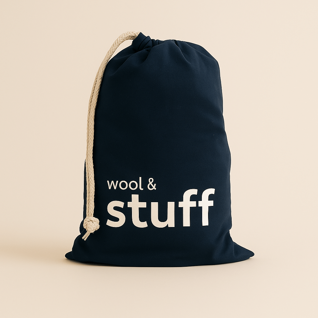 Navy drawstring bag with 'wool & stuff' text on a beige background